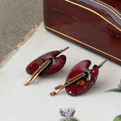 Vintage Matisse Renoir red enamel and copper artist palette earrings with miniature paintbrush design, mid‑century modern clip‑ons from the 1950s–1960s.