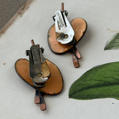 Vintage Matisse Renoir red enamel and copper artist palette earrings with miniature paintbrush design, mid‑century modern clip‑ons from the 1950s–1960s.