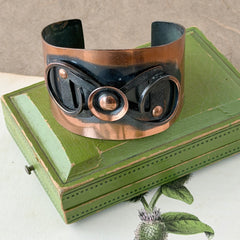 Vintage Modernist copper cuff bracelet with geometric raised design and oxidized black accents, Renoir style, mid‑century Modernist jewelry.