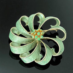 Vintage 1960s floral brooch with light green enamel ribbon petals, gold tone rope edges, and rhinestone center.