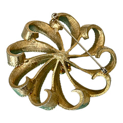 Vintage 1960s floral brooch with light green enamel ribbon petals, gold tone rope edges, and rhinestone center.