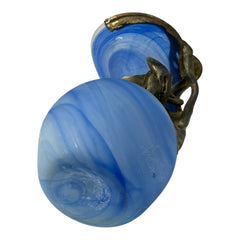 Signed Romanian handblown art glass vase from the 1990s featuring swirling blue glass and sculptural bronze overlay with organic vine-like forms. The vase has a flared top, narrow base, and an undeciphered artist’s signature etched into the glass. A collectible decorative piece in very good vintage condition.