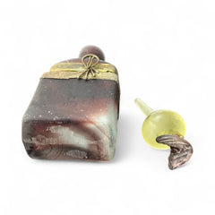 Vintage Romanian art glass perfume bottle with a plum and yellow frosted body, square base, and rounded neck, adorned with bronze wire and a sculptural stopper featuring a translucent yellow-green bead and plum-toned top.