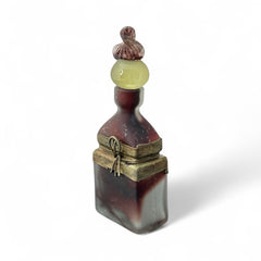 Vintage Romanian art glass perfume bottle with a plum and yellow frosted body, square base, and rounded neck, adorned with bronze wire and a sculptural stopper featuring a translucent yellow-green bead and plum-toned top.