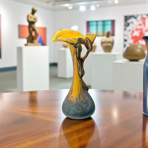 Vintage Romanian art glass vase from the 1990s featuring a frosted teal base, vibrant yellow flared top, and sculptural bronze overlay. Signed by the artist near the base. Elegant and expressive, with subtle surface variation and rich color contrast.