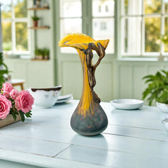 Vintage Romanian art glass vase from the 1990s featuring a frosted teal base, vibrant yellow flared top, and sculptural bronze overlay. Signed by the artist near the base. Elegant and expressive, with subtle surface variation and rich color contrast.