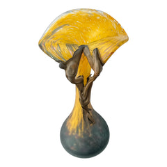 Vintage Romanian art glass vase from the 1990s featuring a frosted teal base, vibrant yellow flared top, and sculptural bronze overlay. Signed by the artist near the base. Elegant and expressive, with subtle surface variation and rich color contrast.