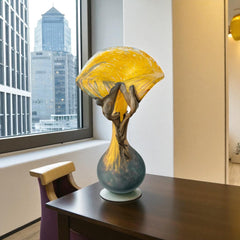 Vintage Romanian art glass vase from the 1990s featuring a frosted teal base, vibrant yellow flared top, and sculptural bronze overlay. Signed by the artist near the base. Elegant and expressive, with subtle surface variation and rich color contrast.