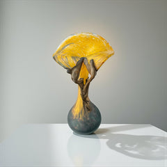 Vintage Romanian art glass vase from the 1990s featuring a frosted teal base, vibrant yellow flared top, and sculptural bronze overlay. Signed by the artist near the base. Elegant and expressive, with subtle surface variation and rich color contrast.