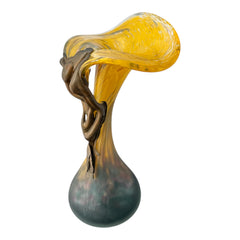 Vintage Romanian art glass vase from the 1990s featuring a frosted teal base, vibrant yellow flared top, and sculptural bronze overlay. Signed by the artist near the base. Elegant and expressive, with subtle surface variation and rich color contrast.