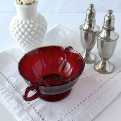 Vintage ruby red double‑handled footed glass bowls with paneled design and subtle amber rim, shown in natural light for color and detail.