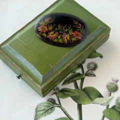 Vintage Russian hand‑painted floral black lacquer oval brooch with red, pink, and yellow flowers and gold detailing.
