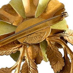 Vintage Sandor yellow enamel flower brooch with green leaves and gold tone accents.