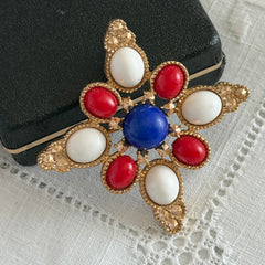 Vintage Sarah Coventry 1972 Americana Maltese cross brooch with red, white and blue cabochons in gold tone