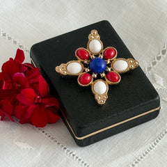 Vintage Sarah Coventry 1972 Americana Maltese cross brooch with red, white and blue cabochons in gold tone