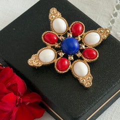 Vintage Sarah Coventry 1972 Americana Maltese cross brooch with red, white and blue cabochons in gold tone