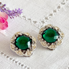 Vintage Sarah Coventry Kathleen emerald and clear rhinestone floral clip‑on earrings, silver‑tone setting.