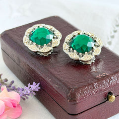 Vintage Sarah Coventry Kathleen emerald and clear rhinestone floral clip‑on earrings, silver‑tone setting.