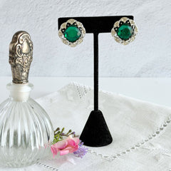 Vintage Sarah Coventry Kathleen emerald and clear rhinestone floral clip‑on earrings, silver‑tone setting.