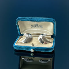 Vintage Sarah Coventry clip-on earrings with shiny silver-tone abstract crescent design; signed on back with copyright symbol, mid-century modernist style in very good condition.