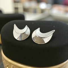 Vintage Sarah Coventry clip-on earrings with shiny silver-tone abstract crescent design; signed on back with copyright symbol, mid-century modernist style in very good condition.
