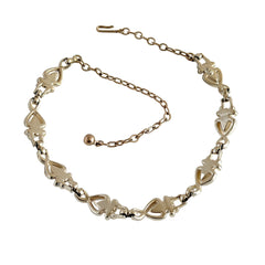 Vintage Sarah Coventry necklace with white ribbed thermoset panels, clear rhinestones, and gold‑tone links, shown from multiple angles to display its mid‑century design.