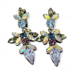 Vintage Schoffel Austria dangle earrings featuring blue, purple, and aurora borealis crystals in silver-tone settings, with floral and teardrop motifs, shown from multiple angles to highlight sparkle, craftsmanship, and signed crown mark.