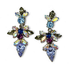 Vintage Schoffel Austria dangle earrings featuring blue, purple, and aurora borealis crystals in silver-tone settings, with floral and teardrop motifs, shown from multiple angles to highlight sparkle, craftsmanship, and signed crown mark.