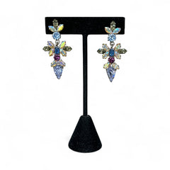 Vintage Schoffel Austria dangle earrings featuring blue, purple, and aurora borealis crystals in silver-tone settings, with floral and teardrop motifs, shown from multiple angles to highlight sparkle, craftsmanship, and signed crown mark.