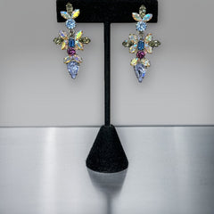 Vintage Schoffel Austria dangle earrings featuring blue, purple, and aurora borealis crystals in silver-tone settings, with floral and teardrop motifs, shown from multiple angles to highlight sparkle, craftsmanship, and signed crown mark.