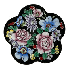 Vintage Seymour Mann flower-shaped trinket box with black enamel exterior, decorated with multicolored floral designs outlined in gold; features a light blue enamel interior and sculpted petal edges.