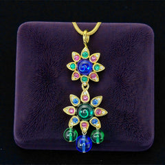 Vintage Shakira Caine Mughal‑style pendant necklace with multicolor glass cabochons, gold tone snake chain, signed and in excellent condition.