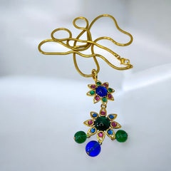 Vintage Shakira Caine Mughal‑style pendant necklace with multicolor glass cabochons, gold tone snake chain, signed and in excellent condition.