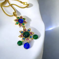 Vintage Shakira Caine Mughal‑style pendant necklace with multicolor glass cabochons, gold tone snake chain, signed and in excellent condition.