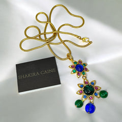 Vintage Shakira Caine Mughal‑style pendant necklace with multicolor glass cabochons, gold tone snake chain, signed and in excellent condition.