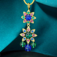 Vintage Shakira Caine Mughal‑style pendant necklace with multicolor glass cabochons, gold tone snake chain, signed and in excellent condition.