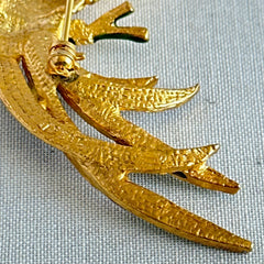 Vintage gold‑tone bird of paradise brooch with navy and green enamel accents, clear pave rhinestones, and a textured metal body, signed Sphinx with model number A2385.