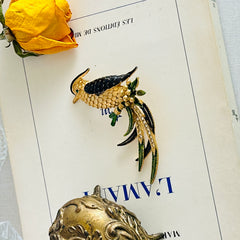 Vintage gold‑tone bird of paradise brooch with navy and green enamel accents, clear pave rhinestones, and a textured metal body, signed Sphinx with model number A2385.