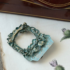 Vintage hand‑painted green and gold tone floral basket brooch with rhinestone accents, shown from multiple angles.