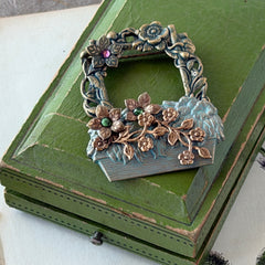 Vintage hand‑painted green and gold tone floral basket brooch with rhinestone accents, shown from multiple angles.