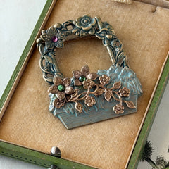 Vintage hand‑painted green and gold tone floral basket brooch with rhinestone accents, shown from multiple angles.