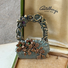 Vintage hand‑painted green and gold tone floral basket brooch with rhinestone accents, shown from multiple angles.