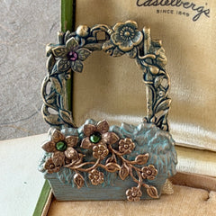 Vintage hand‑painted green and gold tone floral basket brooch with rhinestone accents, shown from multiple angles.