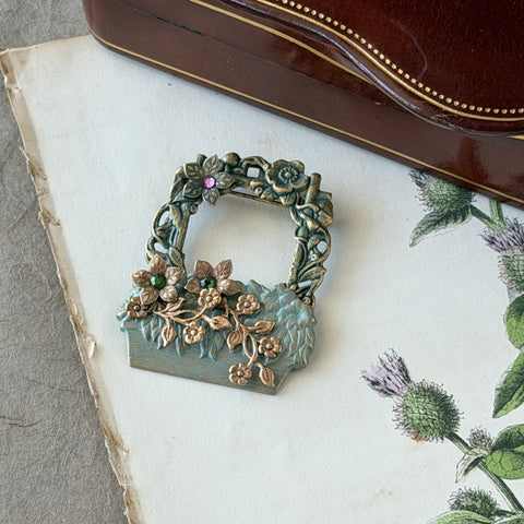 Vintage hand‑painted green and gold tone floral basket brooch with rhinestone accents, shown from multiple angles.
