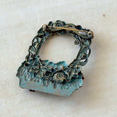 Vintage hand‑painted green and gold tone floral basket brooch with rhinestone accents, shown from multiple angles.