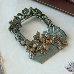 Vintage hand‑painted green and gold tone floral basket brooch with rhinestone accents, shown from multiple angles.