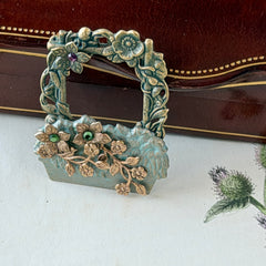 Vintage hand‑painted green and gold tone floral basket brooch with rhinestone accents, shown from multiple angles.
