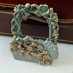 Vintage hand‑painted green and gold tone floral basket brooch with rhinestone accents, shown from multiple angles.