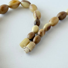Vintage Scottish stag horn antler necklace with graduated oval beads and screw clasp, shown on display and close‑up to highlight natural horn texture and craftsmanship.