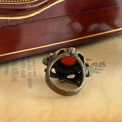 Vintage 1990s Turkish Sultan‑style brass ring with ornate beadwork and cut‑outs, featuring a central carnelian‑colored glass cabochon surrounded by green, ruby, and clear rhinestones on an antique brass setting.